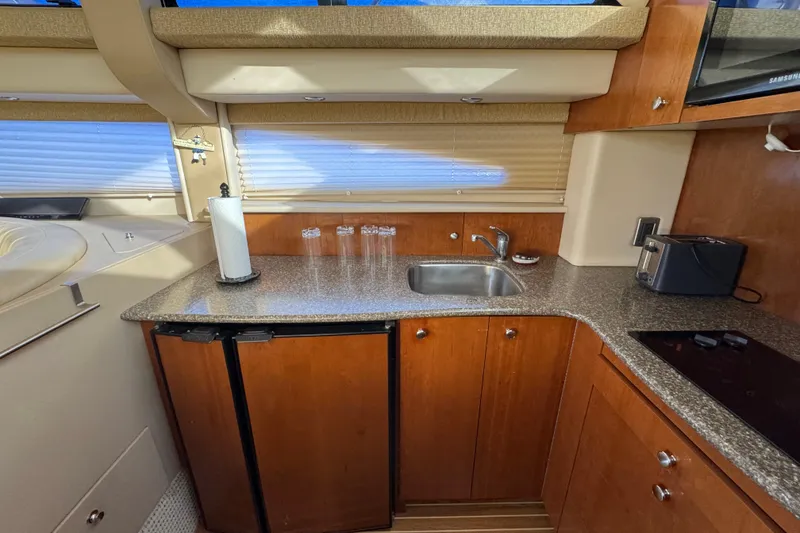 Slide: The Image of 2005 Meridian 368 Motoryacht kitchen with wood cabinets, sink, and appliances. - 38