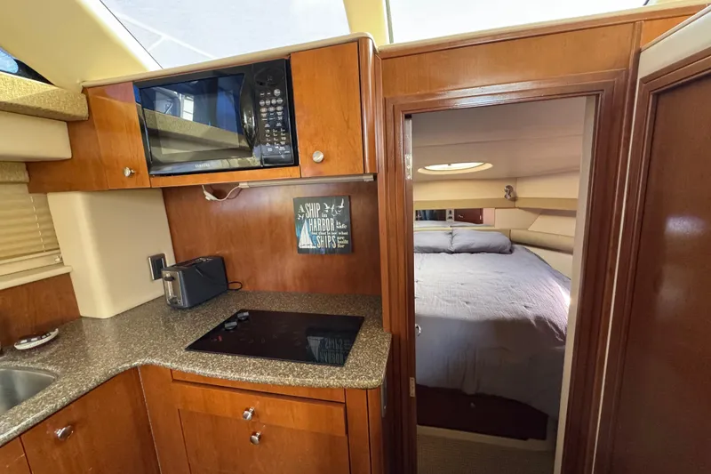 Slide: The Image of 2005 Meridian 368 Motoryacht interior with kitchen and cozy bedroom view. - 40