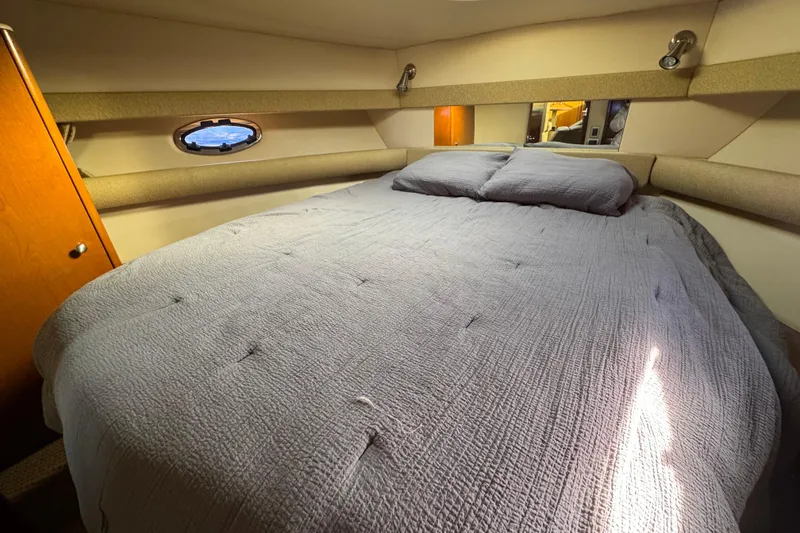 Slide: The Image of 2005 Meridian 368 Motoryacht bedroom with cozy bed and porthole window. - 41