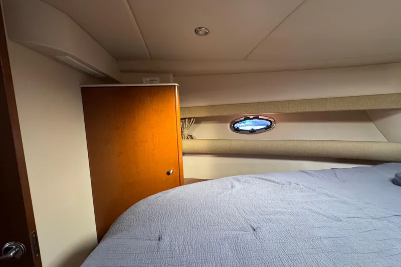 Slide: The Image of 2005 Meridian 368 Motoryacht interior cabin with bed and porthole window. - 42