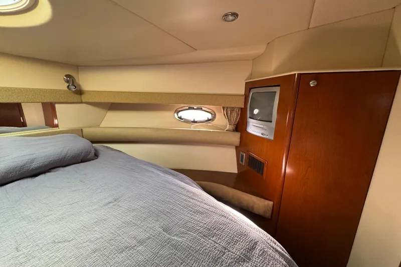 Slide: The Image of Interior of 2005 Meridian 368 Motoryacht with bed, porthole, and built-in TV. - 43