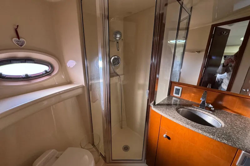 Slide: The Image of Luxurious bathroom in 2005 Meridian 368 Motoryacht with shower, sink, and porthole window. - 46