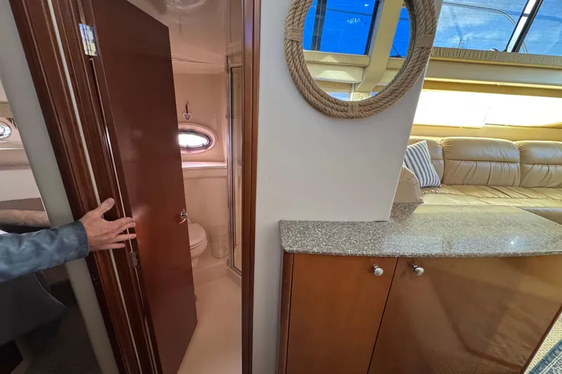 Slide: The Image of 2005 Meridian 368 Motoryacht interior with bathroom, seating area, and nautical decor. - 48