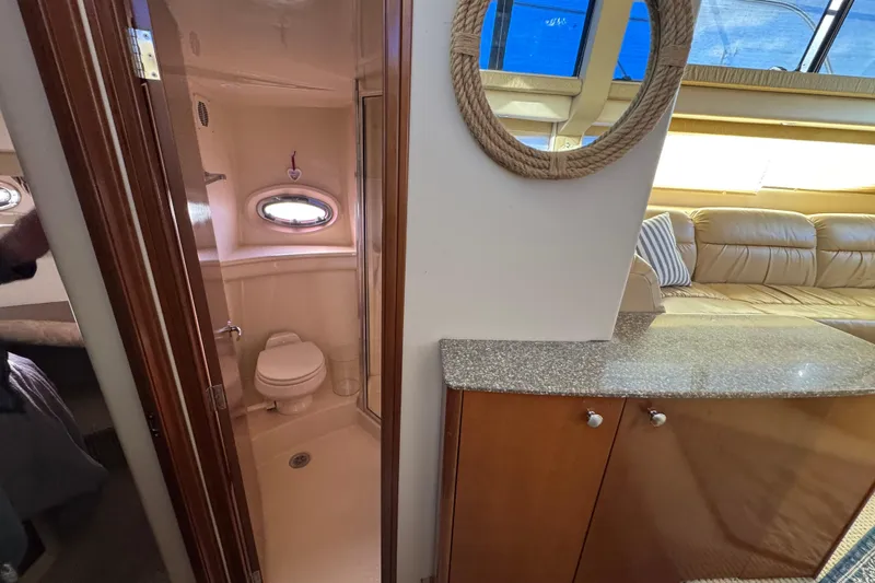 Slide: The Image of 2005 Meridian 368 Motoryacht interior with bathroom, seating area, and nautical decor. - 49
