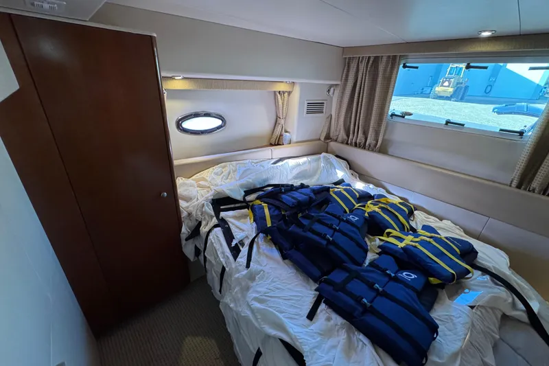 Slide: The Image of 2005 Meridian 368 Motoryacht cabin with life jackets on bed. - 51