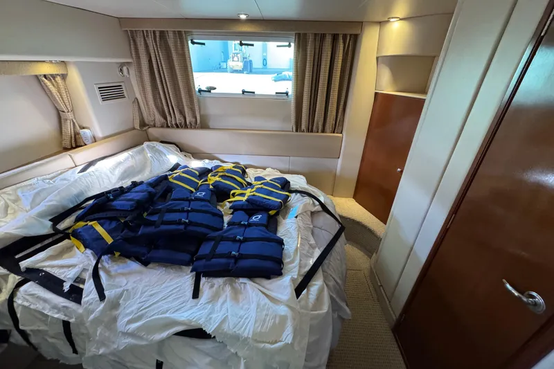 Slide: The Image of 2005 Meridian 368 Motoryacht cabin with life jackets on bed. - 52