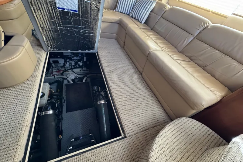 Slide: The Image of 2005 Meridian 368 Motoryacht interior with open engine compartment, beige seating, and carpeted floor. - 58
