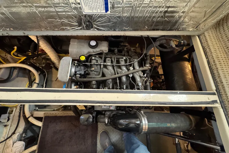 Slide: The Image of Engine compartment of a 2005 Meridian 368 Motoryacht, showcasing mechanical components and wiring. - 62