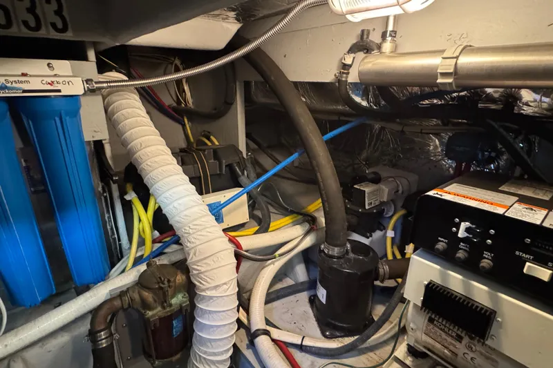 Slide: The Image of Engine room of a 2005 Meridian 368 Motoryacht with various mechanical components and wiring. - 65