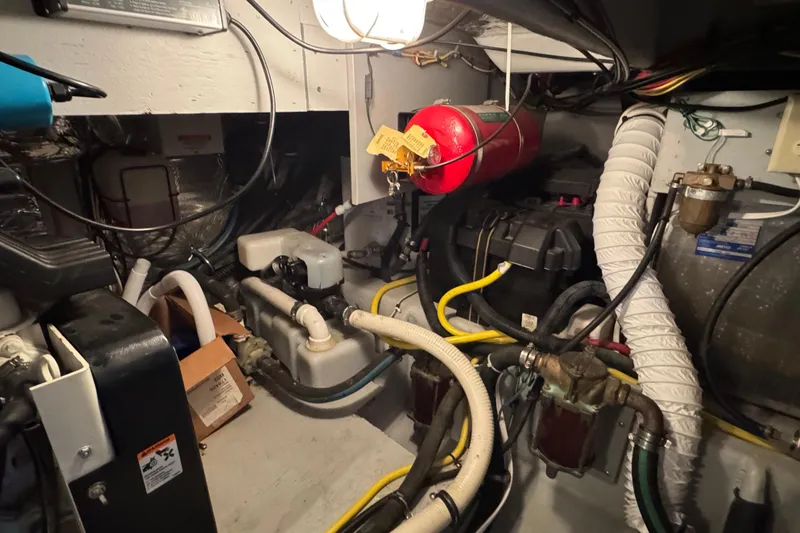 Slide: The Image of Engine room of 2005 Meridian 368 Motoryacht with hoses, wires, and fire extinguisher. - 66