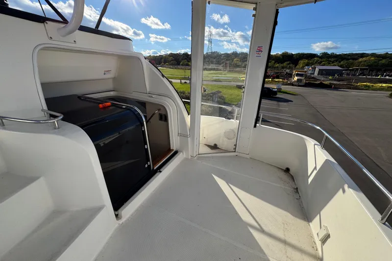 Slide: The Image of 2005 Meridian 368 Motoryacht deck with sunny outdoor view and sleek design. - 9