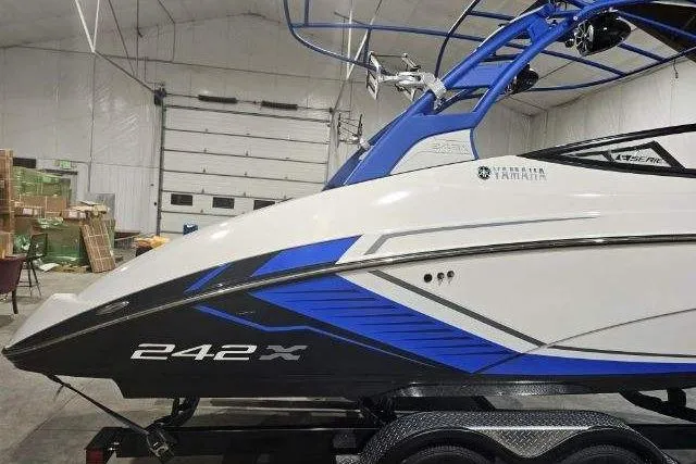 Slide: The Image of 2018 Yamaha Boats 242X in a garage, featuring sleek blue and white design. - 3