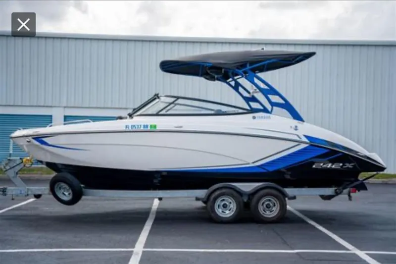 Slide: The Image of 2018 Yamaha Boats 242X on trailer, parked outdoors, side view. - 4