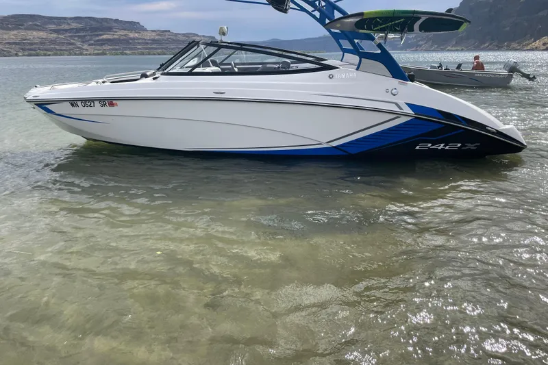 Slide: The Image of 2018 Yamaha Boats 242X in shallow water, showcasing sleek design and vibrant colors. - 5