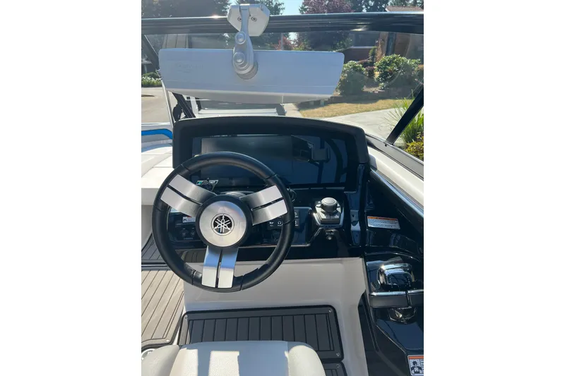 Slide: The Image of Steering console of 2018 Yamaha Boats 242X, featuring modern controls and sleek design. - 6