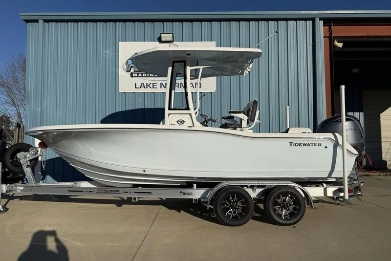 The Image of 2026 Tidewater 210 LXF boat on trailer, parked outside a blue building. - 0