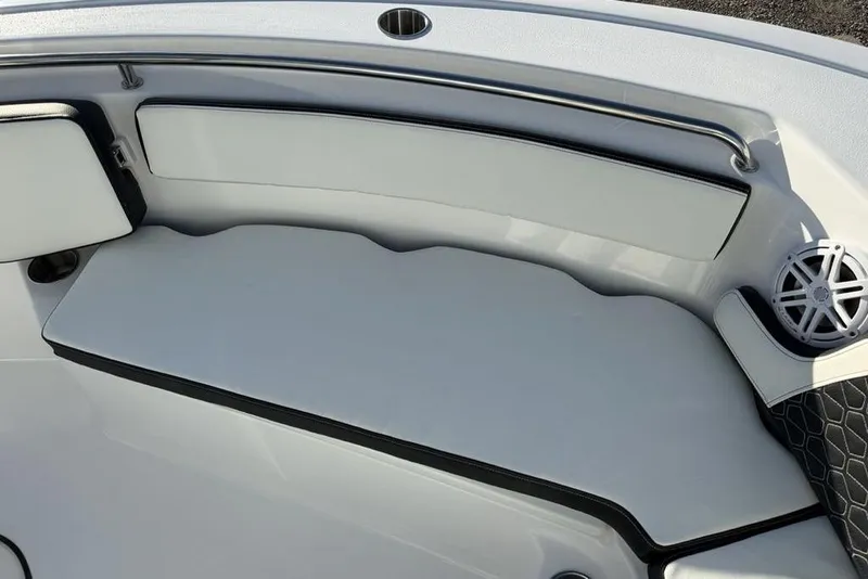 Slide: The Image of 2026 Tidewater 210 LXF boat interior with cushioned seating and speaker. - 11