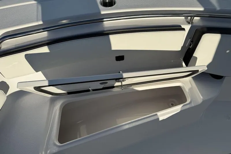Slide: The Image of 2026 Tidewater 210 LXF boat storage compartment with open lid, showcasing spacious interior. - 12