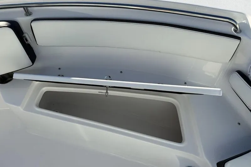 Slide: The Image of 2026 Tidewater 210 LXF boat storage compartment with open lid, showcasing spacious interior. - 13