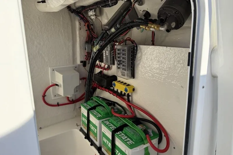 Slide: The Image of Electrical system inside 2026 Tidewater 210 LXF boat, featuring batteries and wiring. - 16