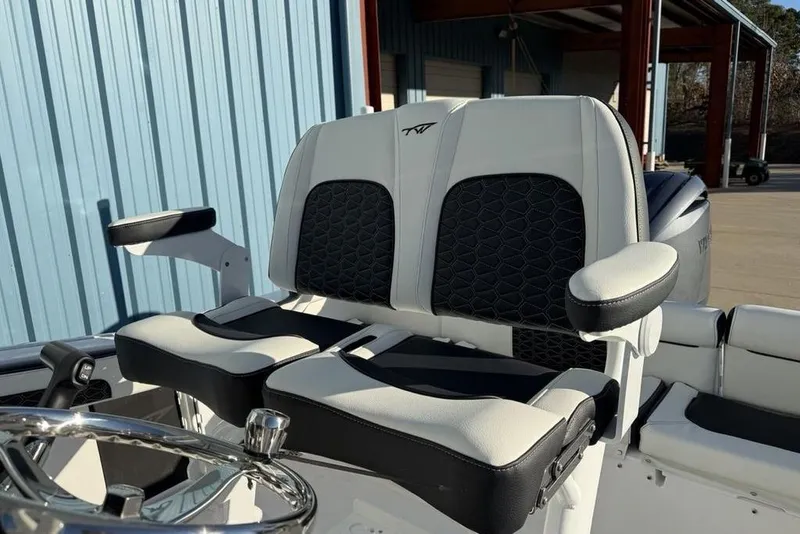 Slide: The Image of 2026 Tidewater 210 LXF boat seats with black and white upholstery, outdoor setting. - 17