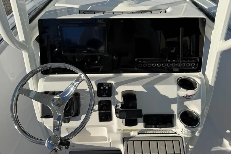 Slide: The Image of 2026 Tidewater 210 LXF boat dashboard with steering wheel and control panel. - 19