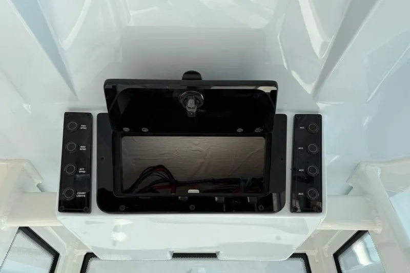 Slide: The Image of 2026 Tidewater 210 LXF boat dashboard with control panel and storage compartment. - 21