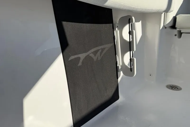 Slide: The Image of 2026 Tidewater 210 LXF boat interior detail with logo and seating. - 23