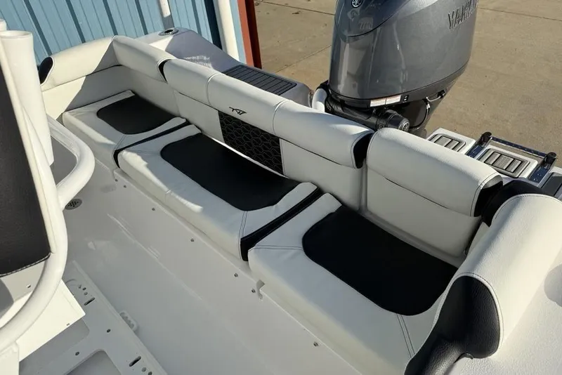 Slide: The Image of 2026 Tidewater 210 LXF boat interior with cushioned seating and Yamaha outboard motor. - 25