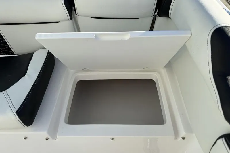 Slide: The Image of Open storage compartment on 2026 Tidewater 210 LXF boat with cushioned seating. - 30