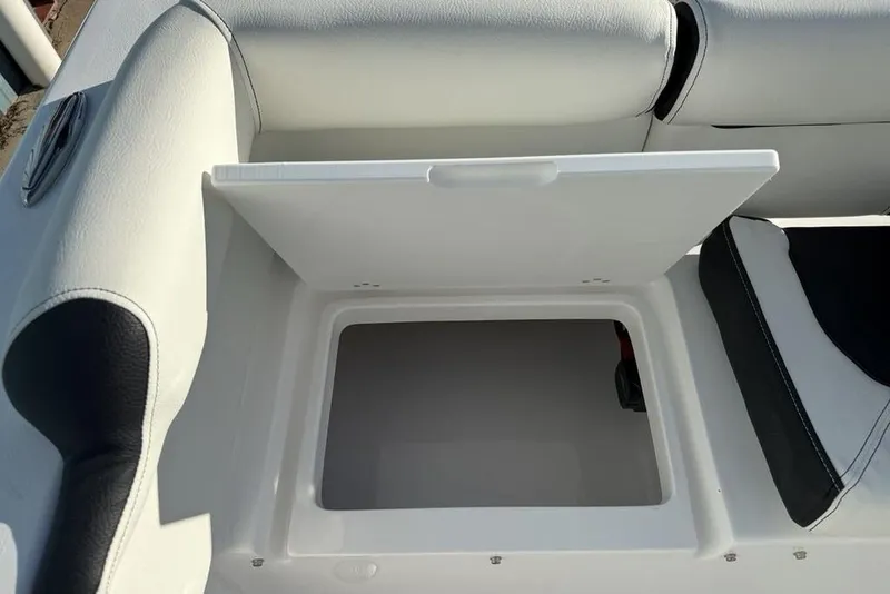 Slide: The Image of Open storage compartment on 2026 Tidewater 210 LXF boat with cushioned seating. - 33