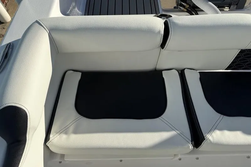 Slide: The Image of 2026 Tidewater 210 LXF boat interior with white and black cushioned seating. - 34