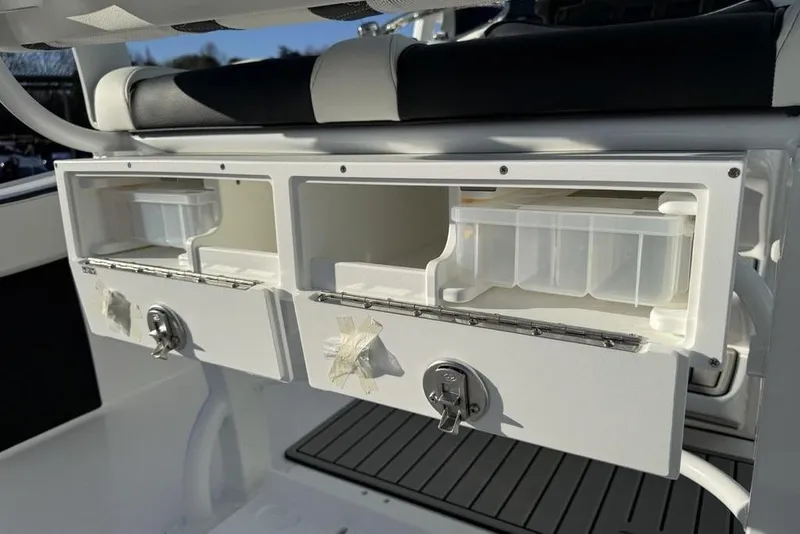 Slide: The Image of Tidewater 210 LXF 2026 boat storage compartments with secure locks and organized trays. - 35
