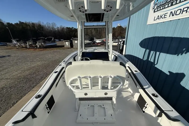Slide: The Image of 2026 Tidewater 210 LXF boat interior with seating and rod holders at a marine center. - 36