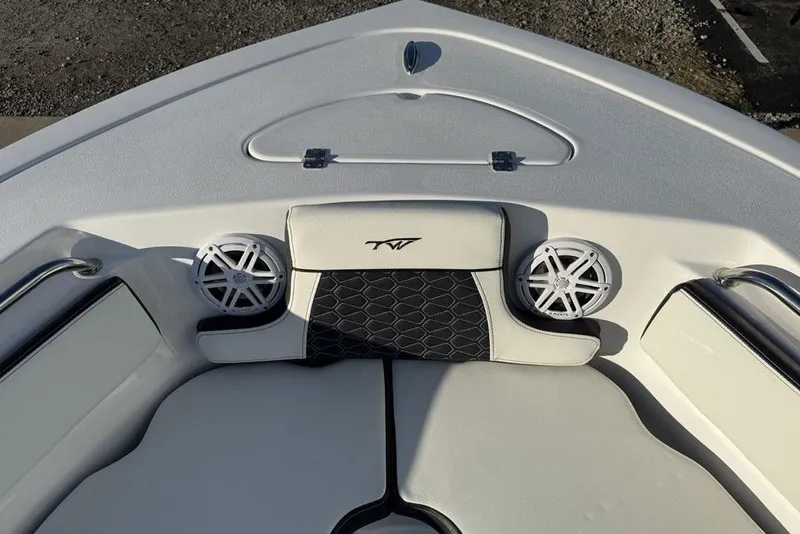 Slide: The Image of 2026 Tidewater 210 LXF boat interior with cushioned seating and built-in speakers. - 4