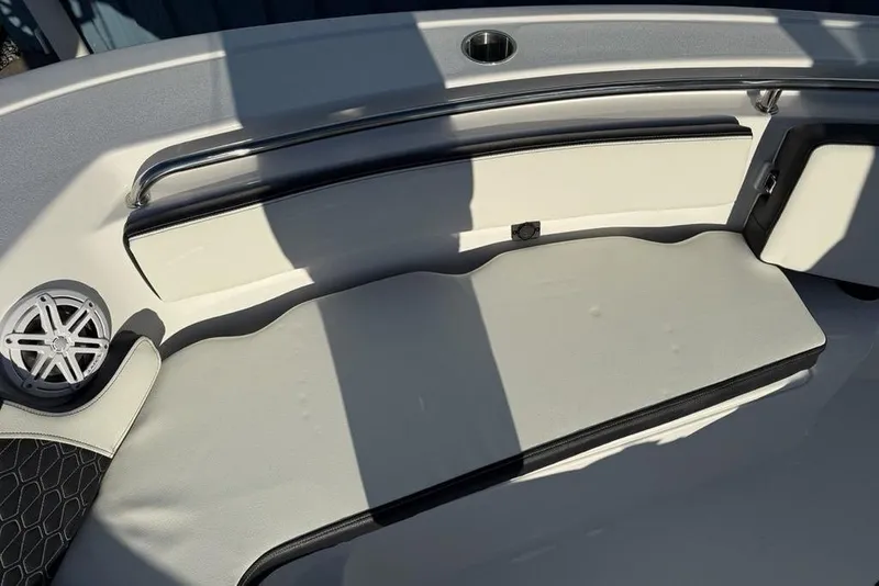 Slide: The Image of 2026 Tidewater 210 LXF boat interior with cushioned seating and speaker. - 7