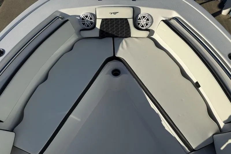Slide: The Image of 2026 Tidewater 210 LXF boat interior with cushioned seating and speakers. - 9