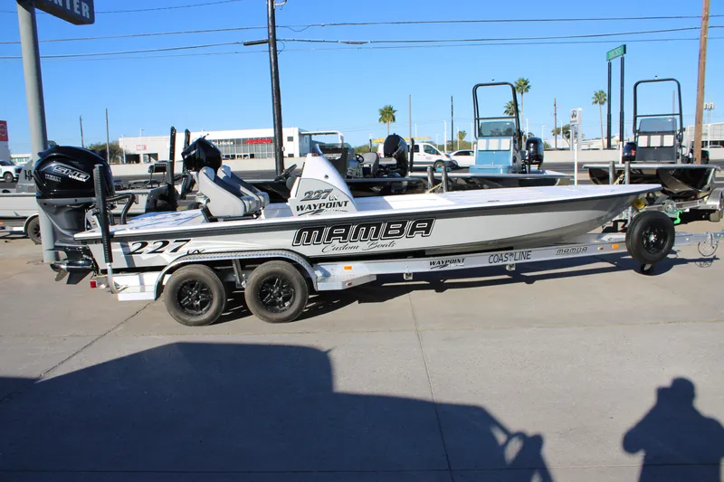 Slide: The Image of 2026 Mamba 227VX boat on trailer with Yamaha engine, parked outdoors. - 21