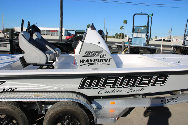 Slide: The Image of 2026 Mamba 227VX boat with custom seating and sleek design on a trailer. - 4