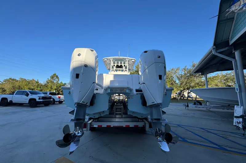 Slide: The Image of 2026 Caymas 34 CT boat with dual outboard motors on a trailer. - 10