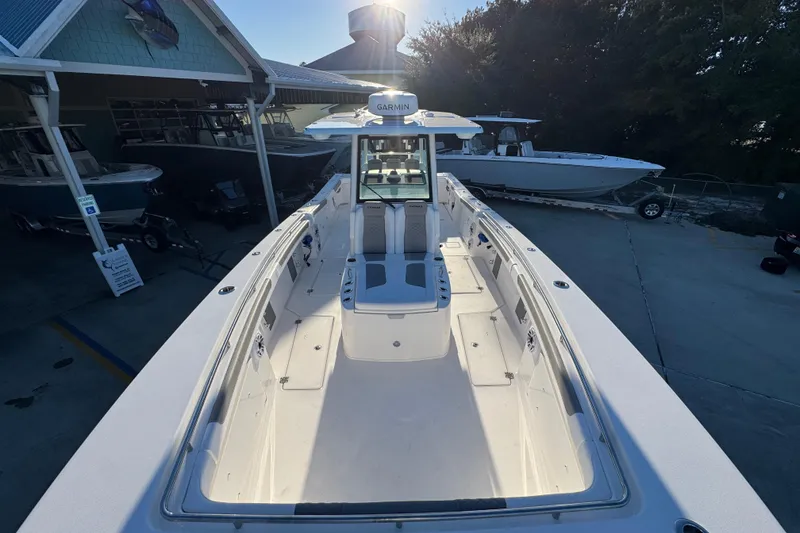 Slide: The Image of 2026 Caymas 34 CT boat docked, showcasing spacious deck and modern design. - 13