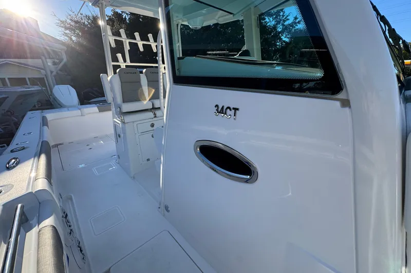 Slide: The Image of 2026 Caymas 34 CT boat interior with seating and sunlight. - 19