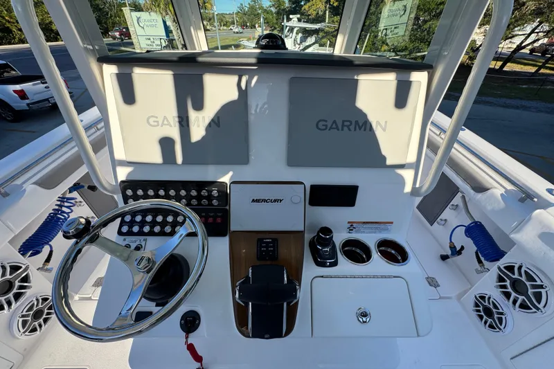 Slide: The Image of 2026 Caymas 34 CT boat dashboard with Garmin displays and Mercury controls. - 24