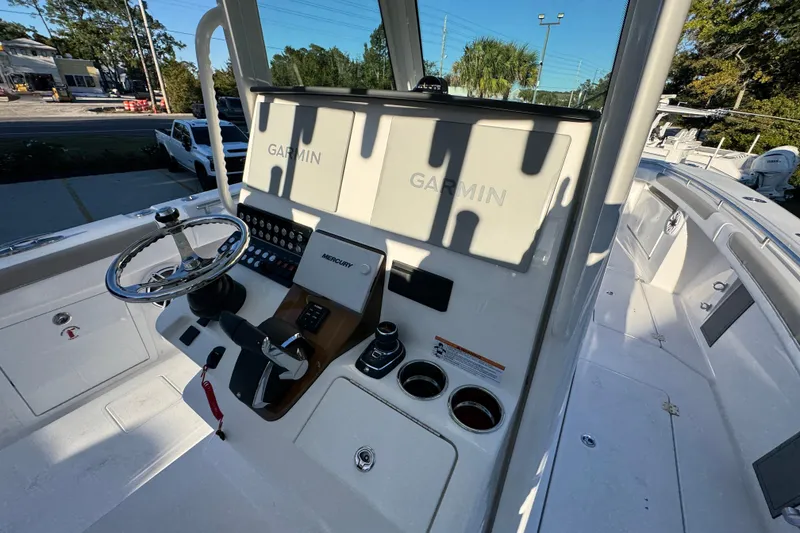 Slide: The Image of 2026 Caymas 34 CT boat cockpit with Garmin navigation system and steering wheel. - 26