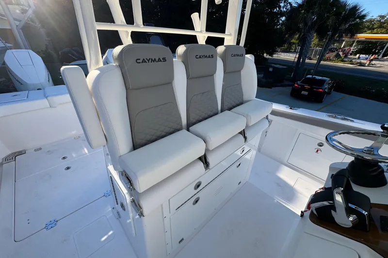 Slide: The Image of 2026 Caymas 34 CT boat interior with cushioned seating and steering wheel. - 27