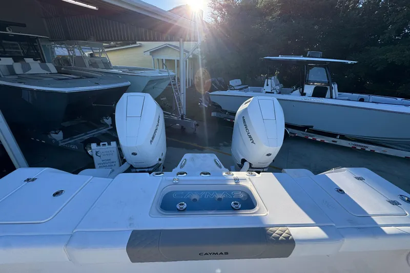 Slide: The Image of 2026 Caymas 34 CT boat with dual Mercury engines in a sunny marina setting. - 33
