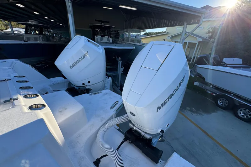 Slide: The Image of 2026 Caymas 34 CT boat with dual Mercury outboard engines in a marina setting. - 34