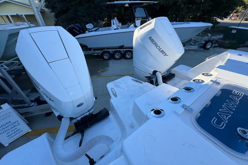 Slide: The Image of 2026 Caymas 34 CT boat with dual Mercury outboard engines. - 35