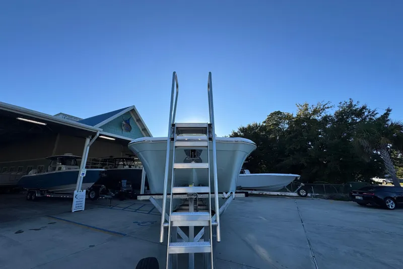 Slide: The Image of 2026 Caymas 34 CT boat on trailer, parked outdoors near a building. - 5