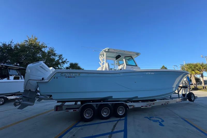 Slide: The Image of 2026 Caymas 34 CT boat on trailer under clear blue sky. - 8